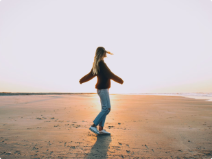 A female walking on the beach